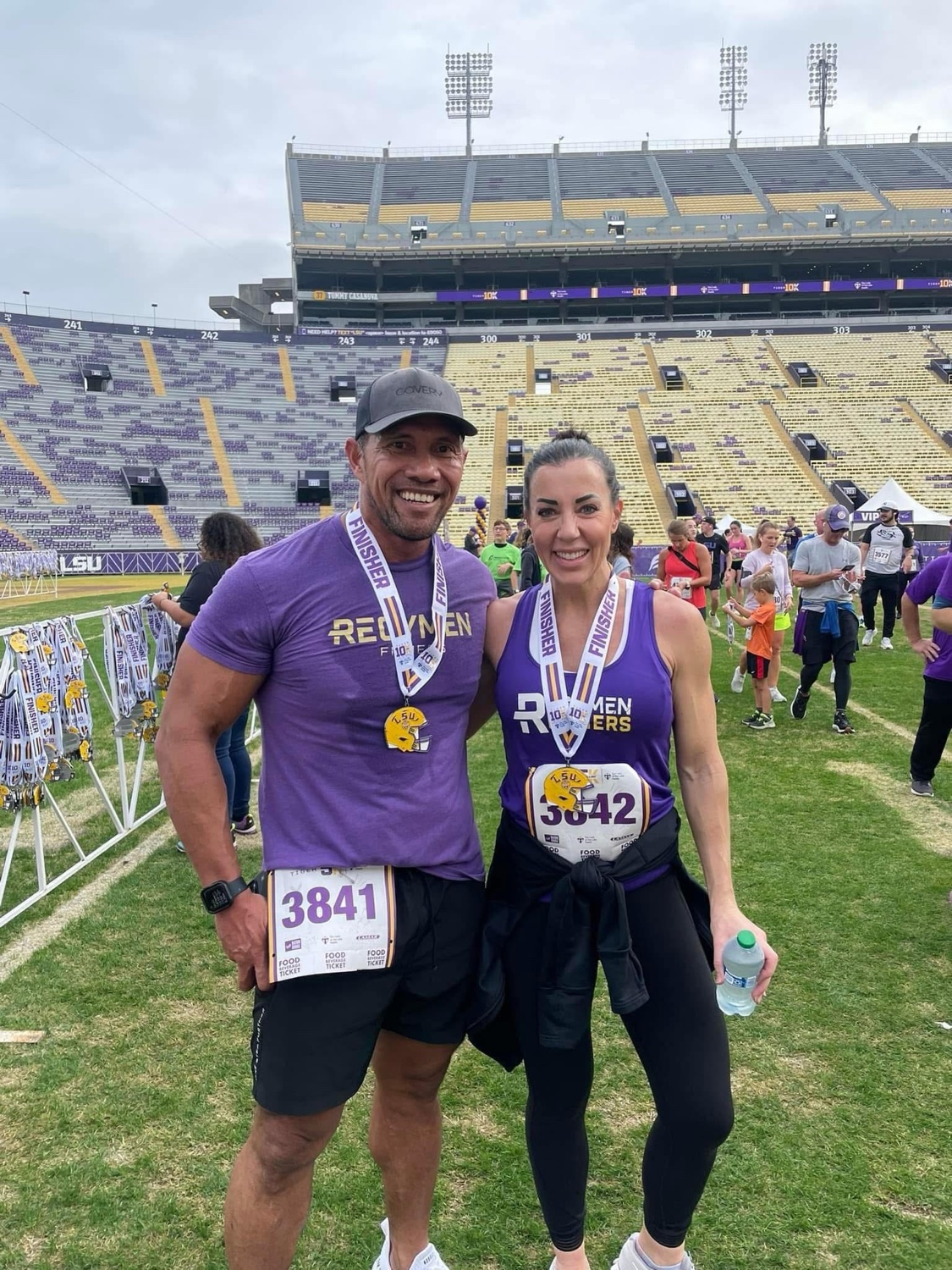 Laie and Emily Wong, owners of SERP Maverick, at LSU Tiger Stadium